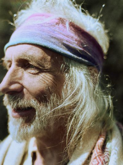 Portrait of an older patient advocate, close-up, warm light.